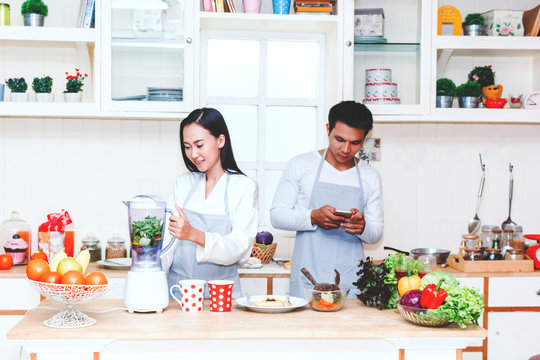 Young couple cooking food in the kitchen