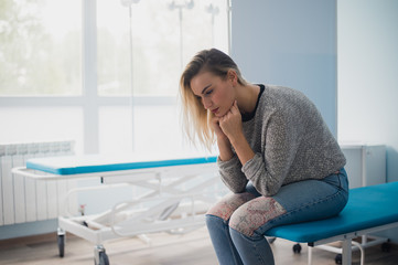 Woman's hand waiting for doctor in hospital feeling worried.