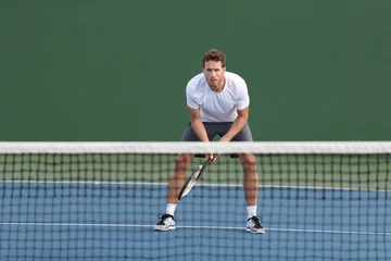 Foto op Canvas Professional tennis player man athlete waiting to receive ball, playing game on hard court. Fitness person focused behind net ready to return training cardio on outdoor sport activity. © Maridav
