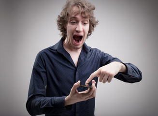 man amused by his smartphone features