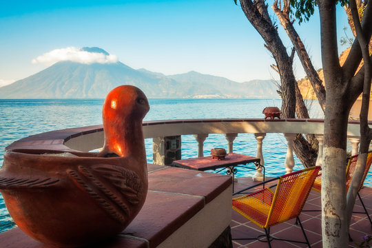'Bird' View of  Volcano San Pedro with a crown of clouds from a charming round terrace at a resort up hill of the shore of Lake Atitlan in Guatemala.