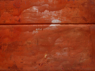 Old red paint on rusty metal