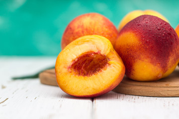 Fototapeta na wymiar a lot of fresh peaches on a white table