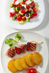Pork Skewer with Potato and Greek Salad