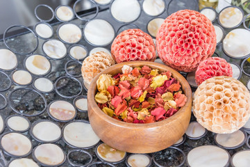 Closeup of wooden bowl with Dried rose petals