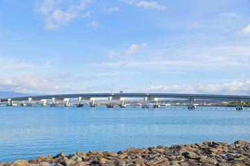 Admiralty Clarey Bridge, Ford Island, Pearl Harbor, Hawaii. Bridge view from the shore stones on a sunny day.