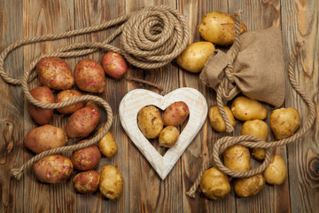 Raw potatoes on a wooden background