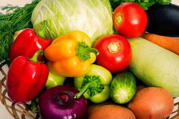 Basket with fresh mixed vegetables on white background