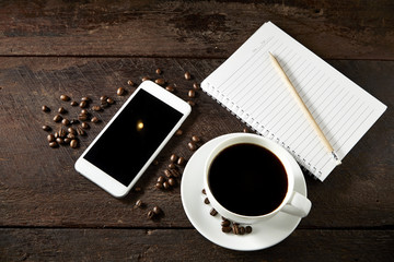 cup of coffee and smartphone on the wood