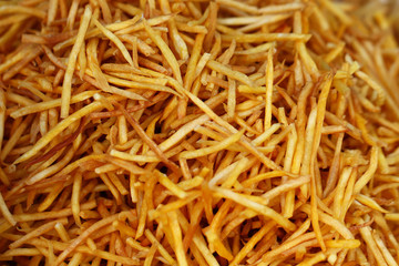 closeup group of French fries, potato, tiny slices, stick, chip, yellow crispy at asia fresh market , secret delicious recipe snack, backgrounds, wallpaper 