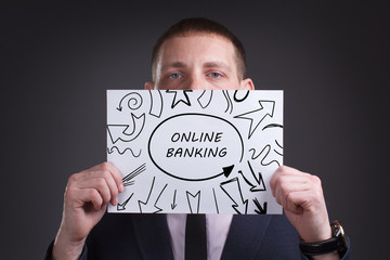 The concept of business, technology, the Internet and the network. Young businessman showing inscription: Online banking