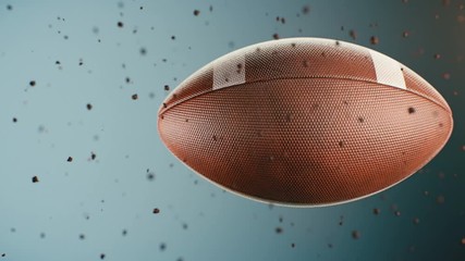 Computer animated sports background with leather football spinning and flying throw dust particles against blue background - Powered by Adobe