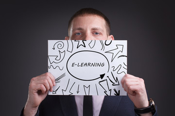 The concept of business, technology, the Internet and the network. Young businessman showing inscription: E-learning