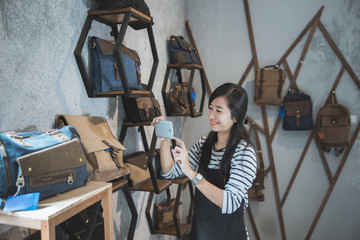 owner taking picture of her product at shop