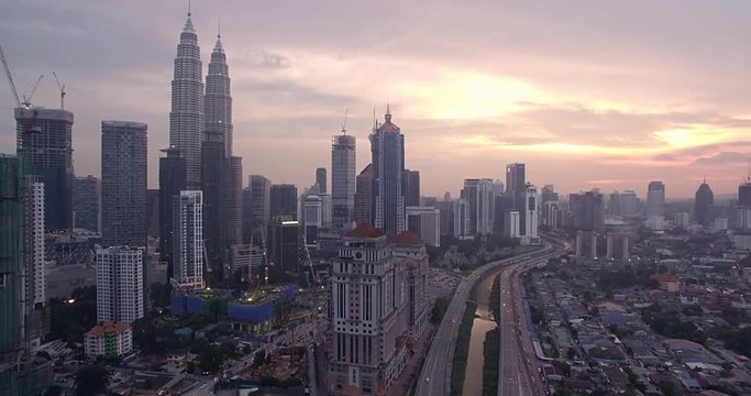 Skyscrapers in Kuala Lumpur City Center, Malaysia, at Sunset, Ascending Aerial Shot