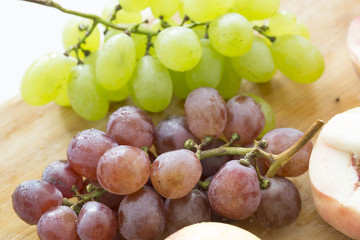 Peaches and grapes on the table. Closeup.