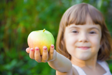 Child with an apple. Selective focus. 