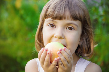 Child with an apple. Selective focus. 