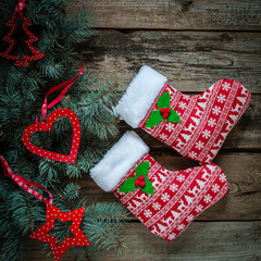 Christmas stockings in christmas pattern on wooden background, Christmas tree with red decor, top view - 167875919