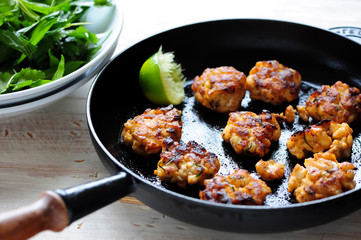 Cooked Thai fish with a lemon in a pan