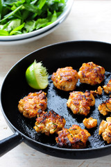 Cooked Thai fish with a lemon in a pan