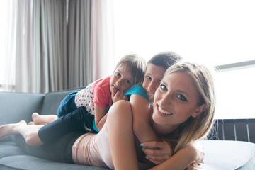 Fototapeta premium young mother spending time with kids on the floor