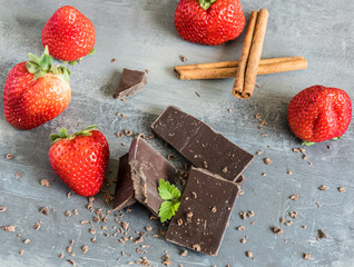 Dairy and bitter chocolate with strawberries and mint leaves