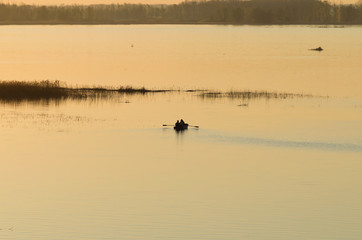 Obraz na płótnie Canvas Fishermen at the dawn swim for fishing