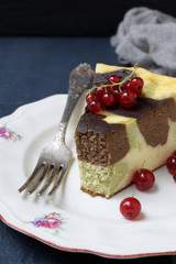 Homemade marble cheesecake with cream cheese, chocolate and tea matcha on a dark background. Copy space. Photographing with natural light