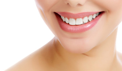 Closeup shot of cheerful smiling female with fresh clear skin, white background, isolated