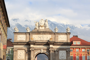 Triumphal Arch (Triumphpforte) and snow mountains in Innsbruck, Austria
