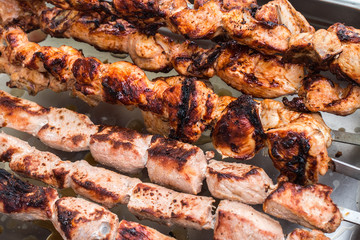 Shashlik roasting on hot grill, one piece scorched