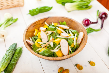 chicken salad bowl on kitchen table, balanced diet
