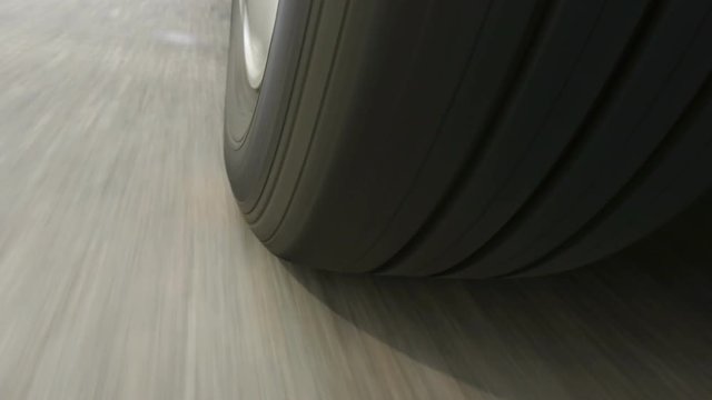 Car wheel spinning, Close UP / Detail Shot / POV - Point of View, day. Fast speed.