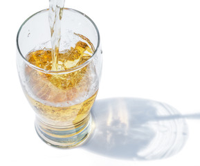 The process of pouring beer into the glass.