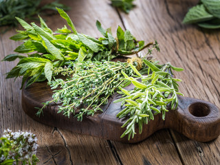 Fresh herbs on the wooden table.