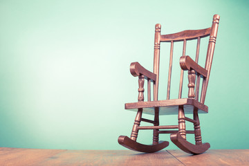 Vintage old wooden toy rocking chair. Retro style filtered photo - obrazy, fototapety, plakaty