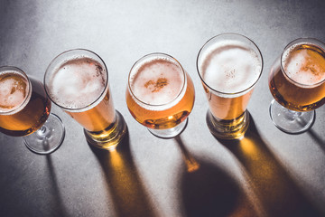 Beer glasses on gray stone background
