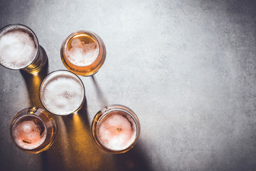Beer glasses on gray stone background