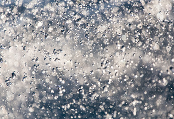 Abstract background of drops of water on the fly