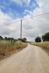 Country road and blue sky with clouds