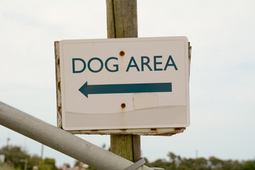 Dog Area sign with direction arrow at the coast