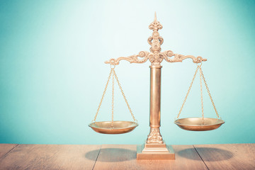Law scales on table. Symbol of justice. Retro style filtered photo