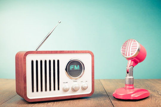 Retro radio, old microphone from 60s front mint green background. Vintage style filtered photo