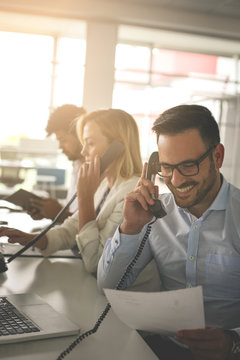 People In Operations Center  Talking On Landline Phone. Operators In The Office.