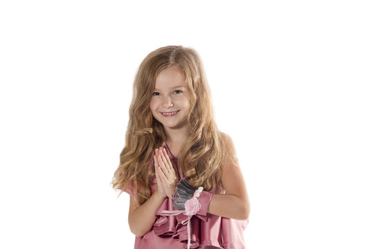 Beautiful smiling little girl praying - closeup portrait, isolated
