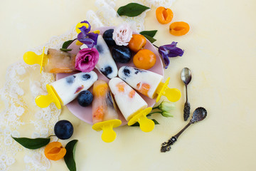 Yogurt ice cream with fruit on a yellow background