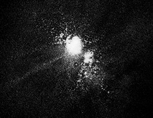 Pile of wheat flour isolated on black background, top view