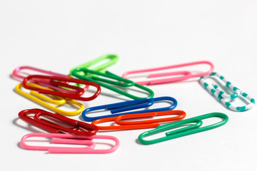 Multicolored paper clips on a white background