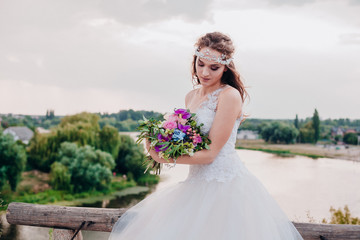 Fototapeta na wymiar Beautiful bride in a light and airy wedding dress